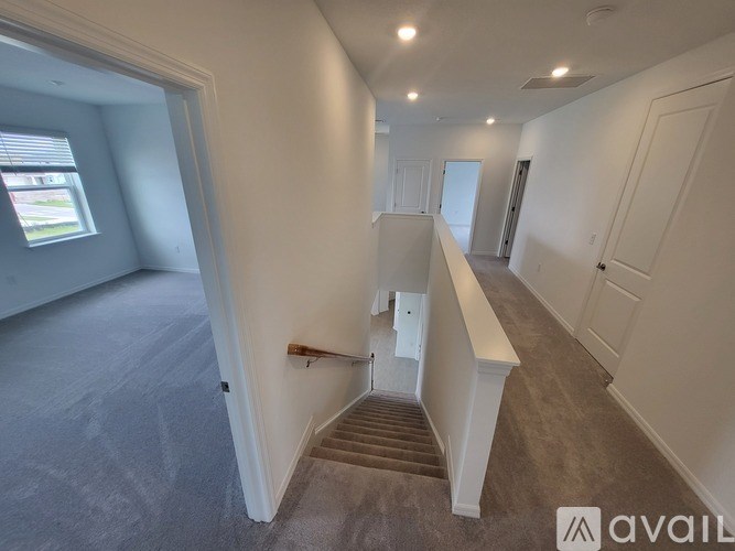 A room with a staircase leading to another room.