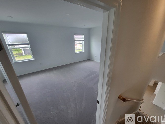 A room with a window and a door is available for rent.