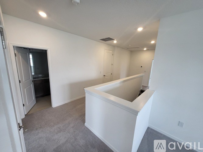 A room with a bathtub and a door leading to a balcony.