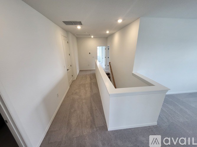 A room with white walls and a grey floor is available for rent.