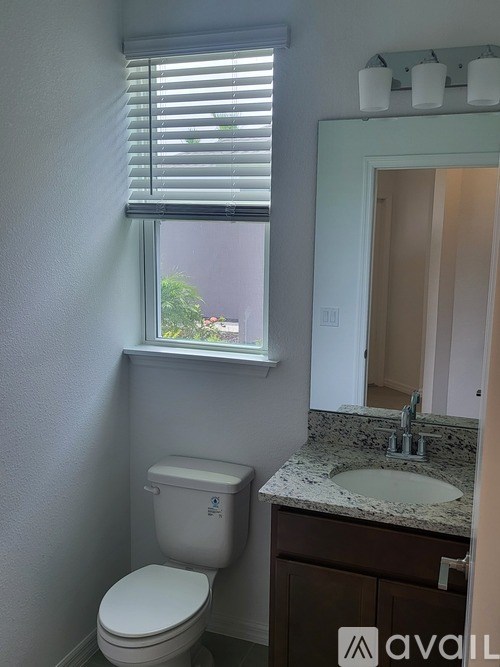 A white toilet sits next to a sink in a bathroom.