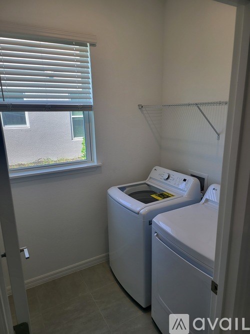 A small laundry room with a washer and dryer.