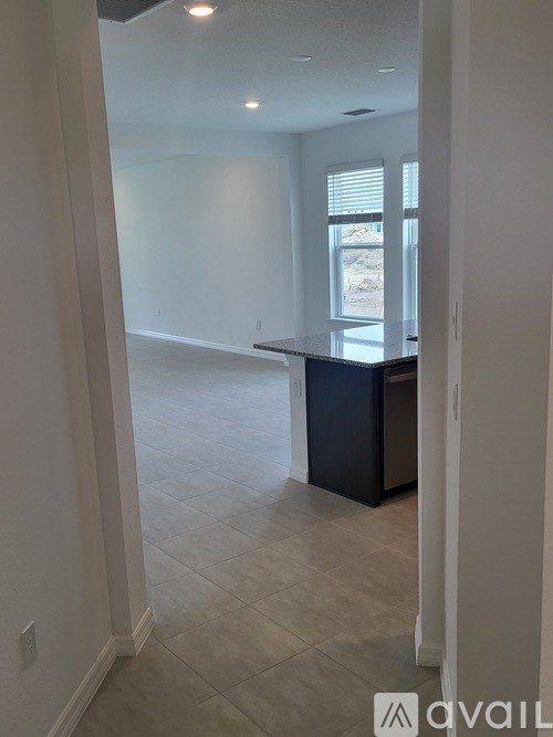 A kitchen area with a bar counter and a window.