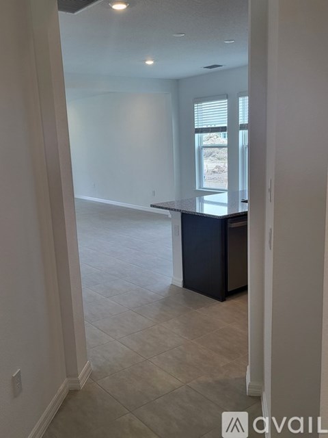 A kitchen area with a bar counter and a window.