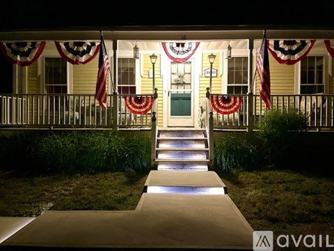 A house entrance decorated with American flags and bunting.