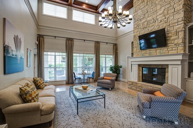 a living room with couches and a fireplace and a tv