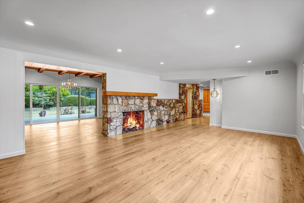 A room with a fireplace and a wooden floor.