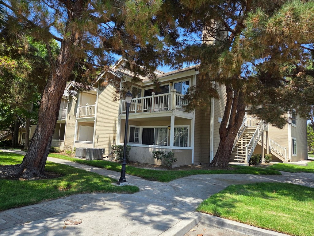 A house with a tree in front of it.