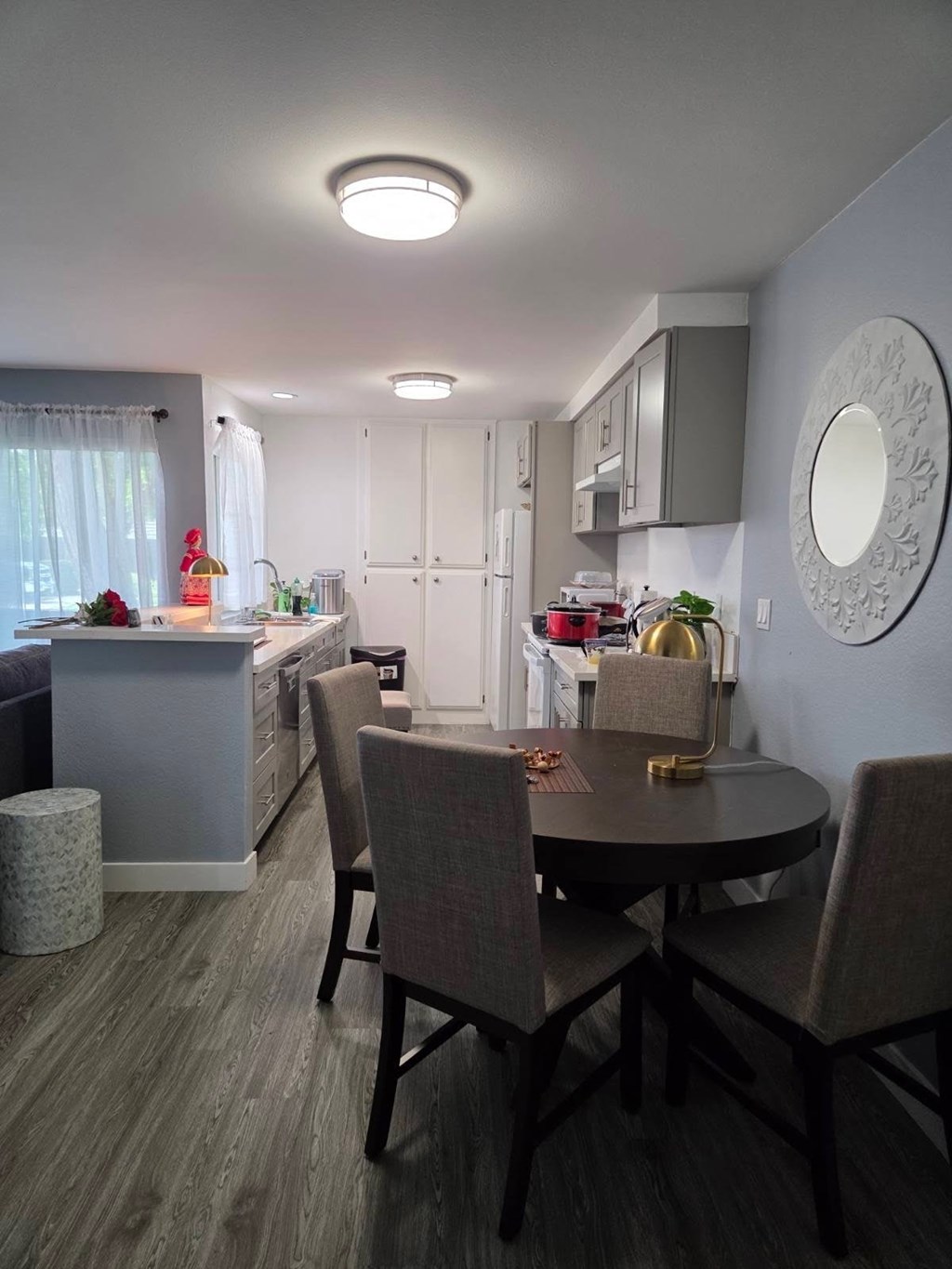 A kitchen with a table and chairs in the foreground.