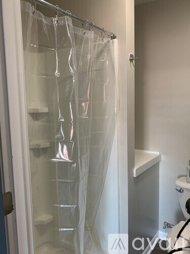A shower curtain is hanging in a bathroom.