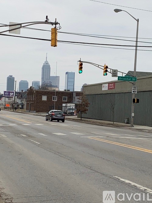 A car is stopped at a green light on a city street.
