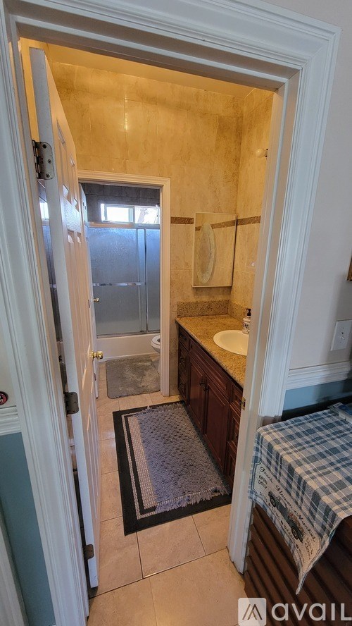 A bathroom with a towel hanging on the door.