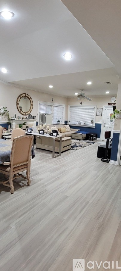 A living room with a dining table and chairs.