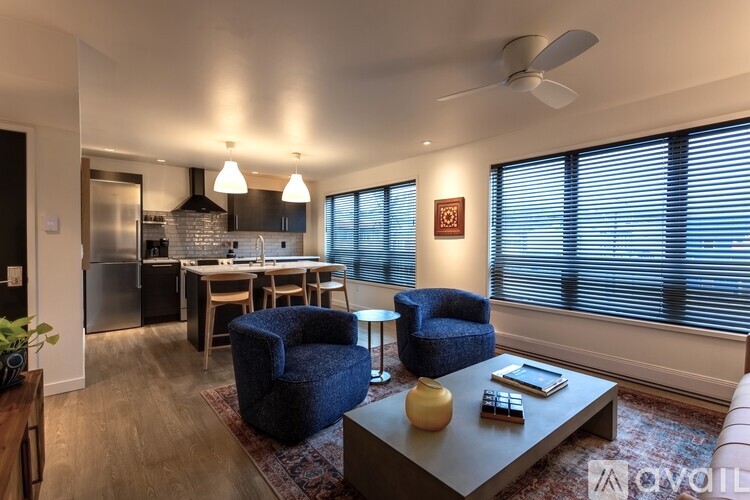 A living room with a blue chair and a grey coffee table.