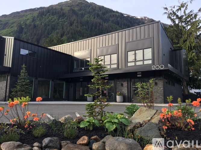 A modern house with a mountain in the background.