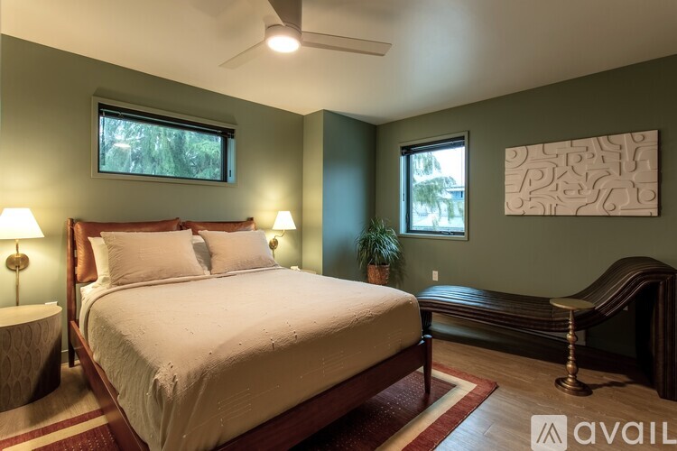 A bedroom with a large bed and a bench.