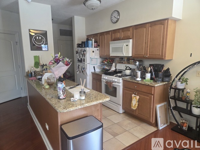 A kitchen with wooden cabinets and a refrigerator.