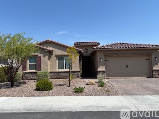 A house with a brown roof and a garage door is for sale.