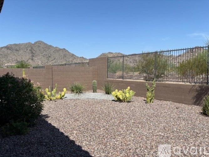A room with a large window and a wooden floor.