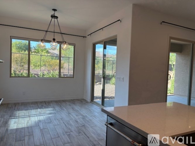 A modern kitchen with a dining table and chairs is available for rent.