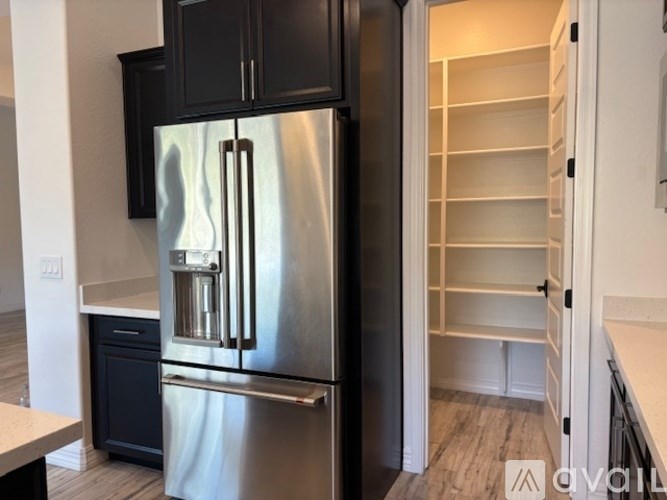 A bathroom with a white countertop and black cabinets.