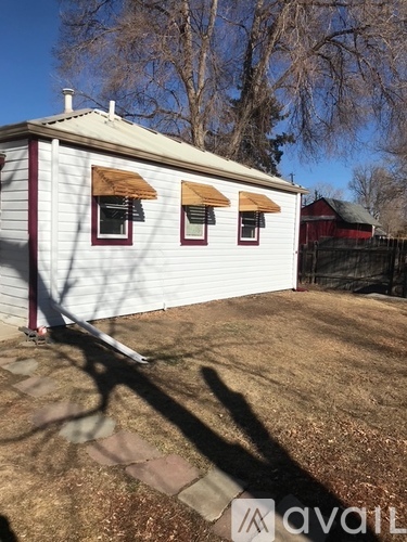 A room with a window and a door is available for rent.