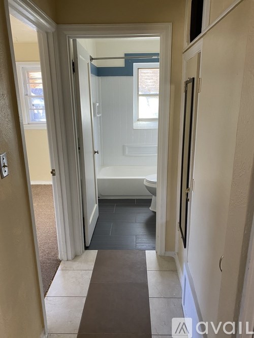 A bathroom with a toilet, sink, and shower.