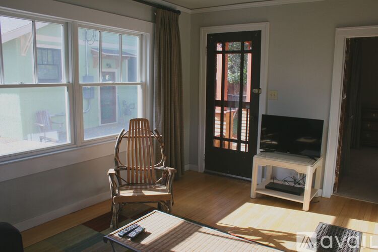 A room with a chair, a table, and a window.
