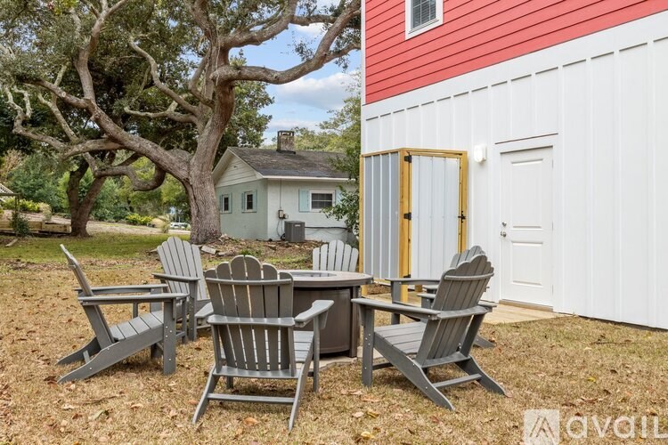 A set of chairs and a table are arranged on a lawn.