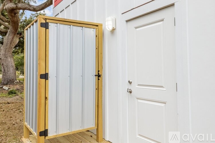 A white door is next to a white wall and a white door.