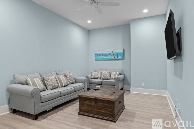 A living room with a grey couch and a wooden coffee table.