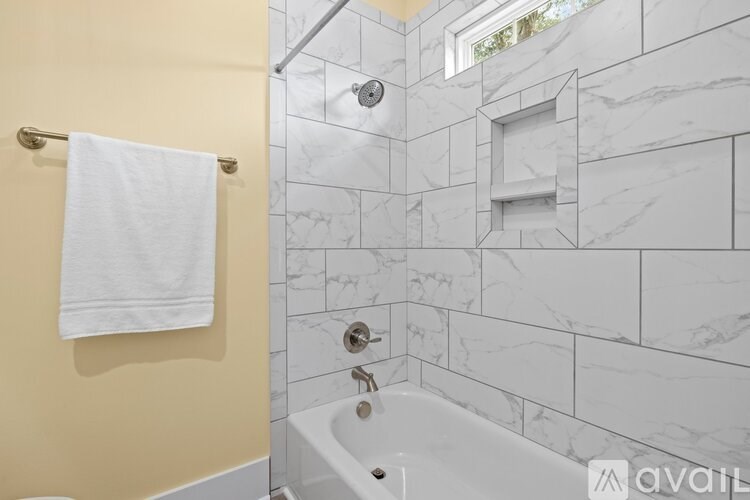 A white towel hangs on a gold towel rack.