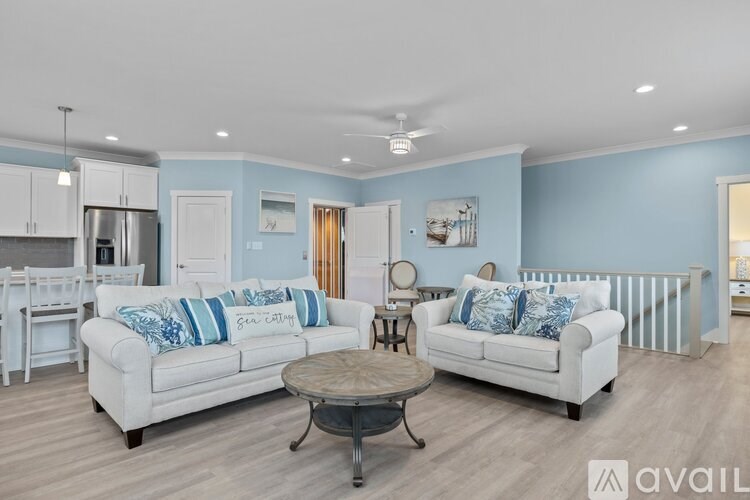 A living room with a white couch and a coffee table.