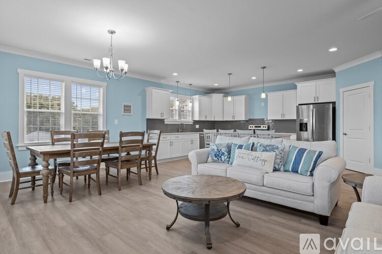 A living room with a dining table and chairs.