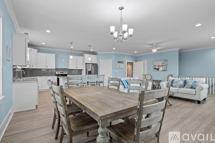 A dining room with a wooden table and chairs.
