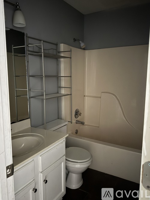 A bathroom with a toilet, sink, and bathtub.