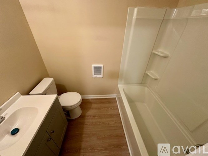 A bathroom with a toilet, sink, and bathtub.