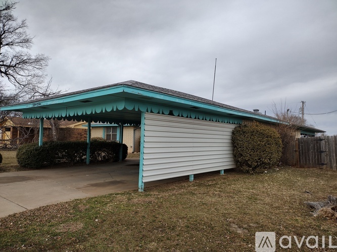 A house with a blue roof and a garage door.