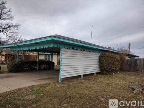 A house with a blue roof and a garage door.