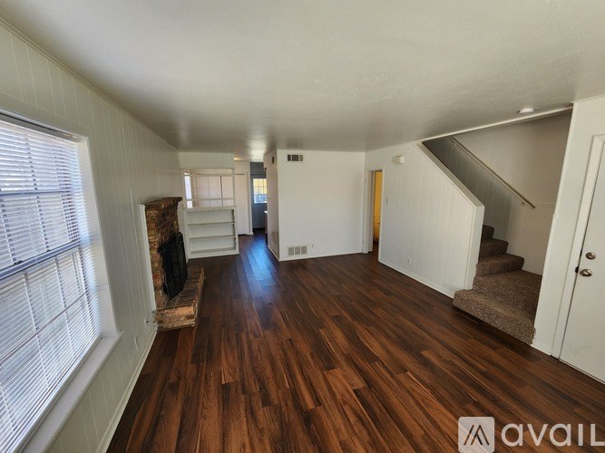 A room with wooden floors and white walls.
