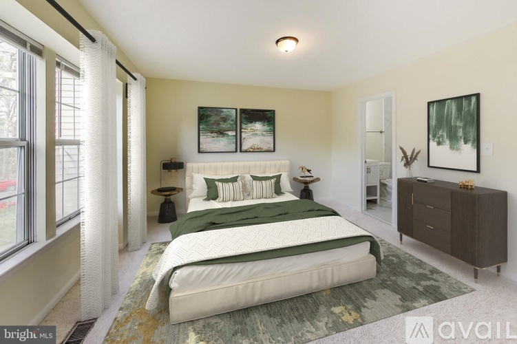 A bedroom with a large bed, a nightstand, and a painting on the wall.