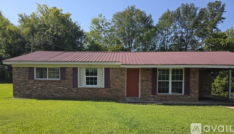 A house with a red door and a red roof is for sale.