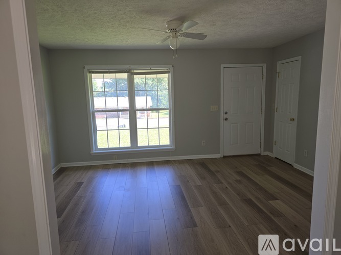 A room with a window and a ceiling fan.
