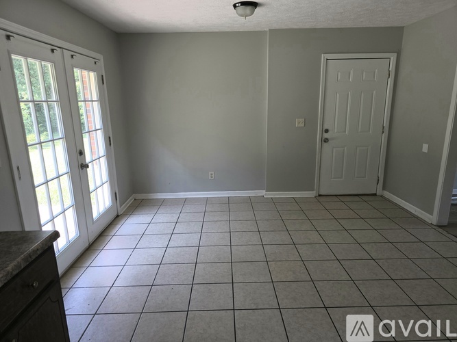 A room with a tiled floor and a door.