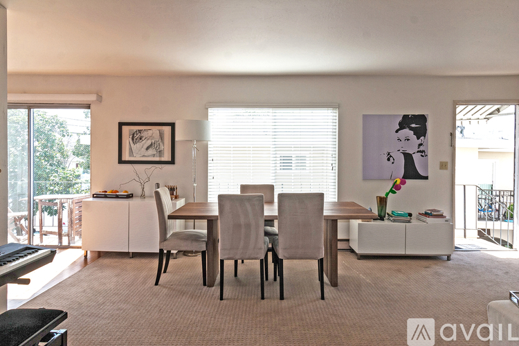 A dining room with a table and chairs.