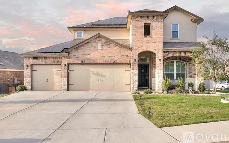 A large house with a garage is available for sale.