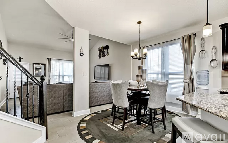A dining room with a table set for four.
