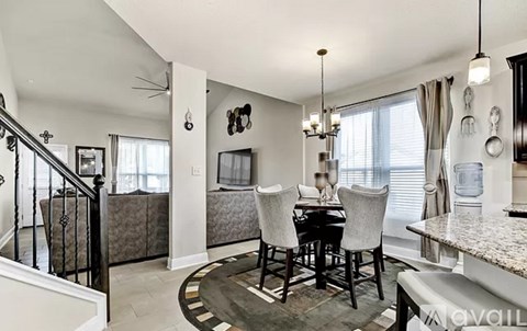 A dining room with a table set for four.