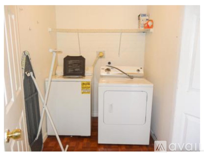 A small laundry room with a washer and dryer.