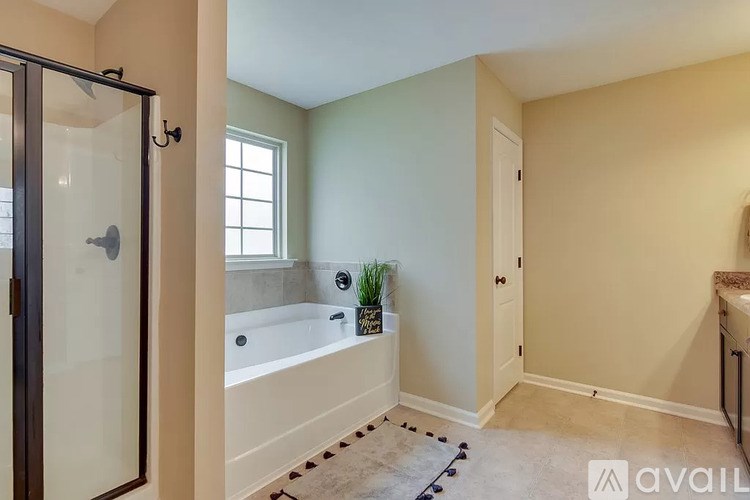 A bathroom with a tub and a window.